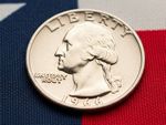 An image of a US Quarter 25 cent piece with an Texas Flag as the backdrop.